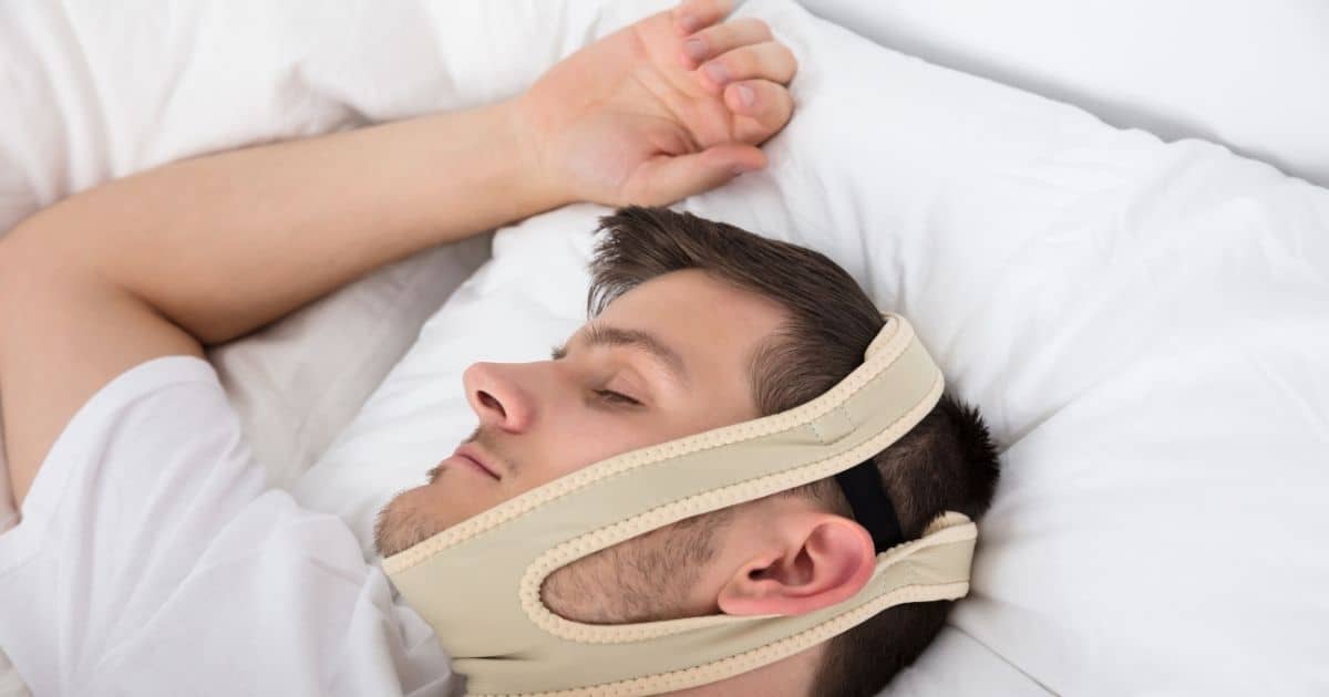 man sleeping wearing chin strap