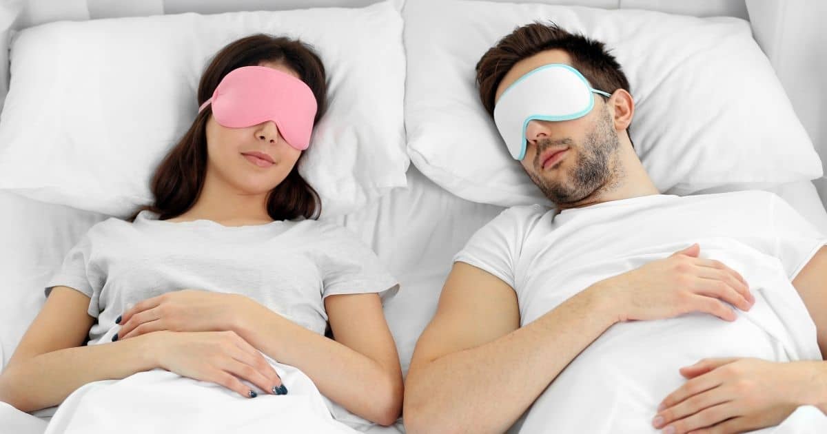 couple in bed wearing eye masks